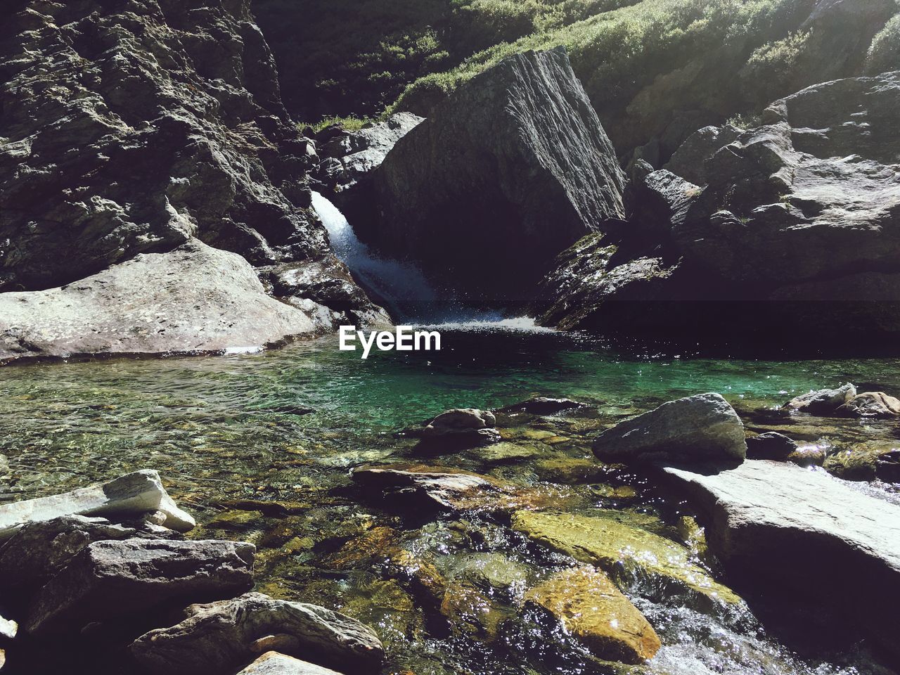 SCENIC VIEW OF ROCK FORMATION BY RIVER