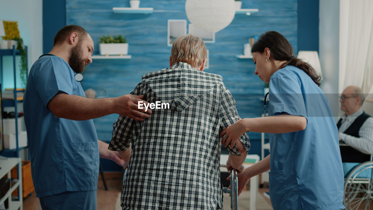 Doctor helping patient at hospital