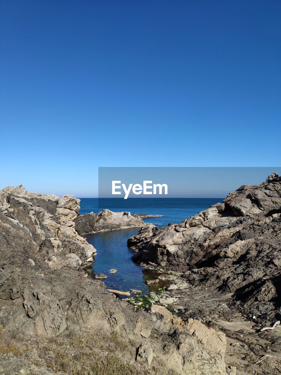 Scenic view of sea against clear blue sky