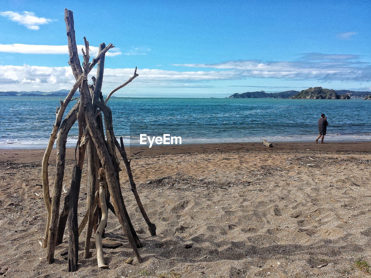 MAN ON SHORE AGAINST SKY