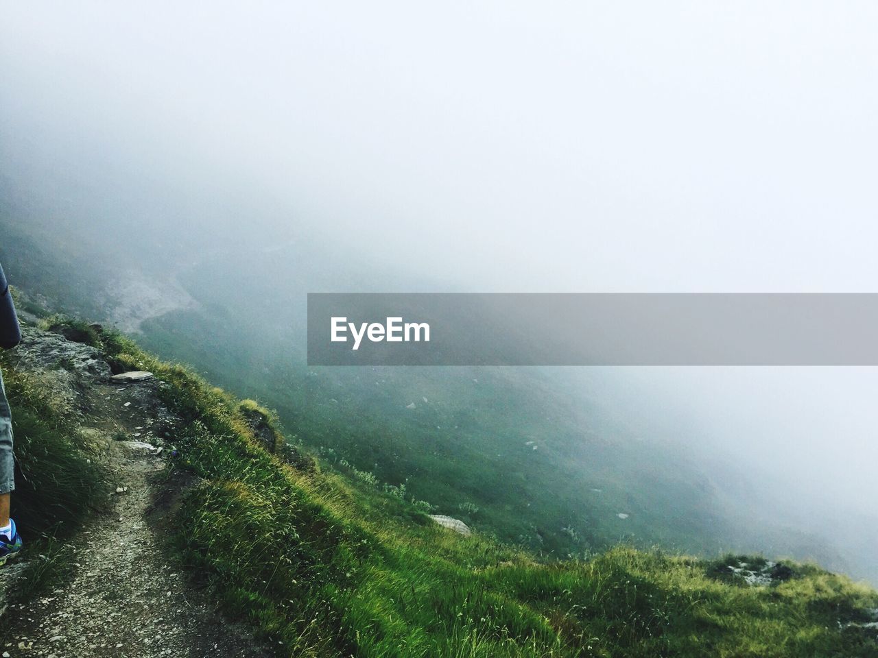 Scenic view of green mountains in foggy weather