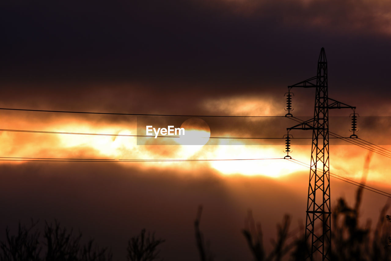 sky, sunset, electricity, technology, cloud, silhouette, nature, cable, electricity pylon, power supply, light, power generation, no people, power line, orange color, beauty in nature, dramatic sky, afterglow, sunlight, scenics - nature, sun, outdoors, evening, tranquility, environment, dawn, landscape, tranquil scene, plant, darkness, architecture, dark, transmission tower