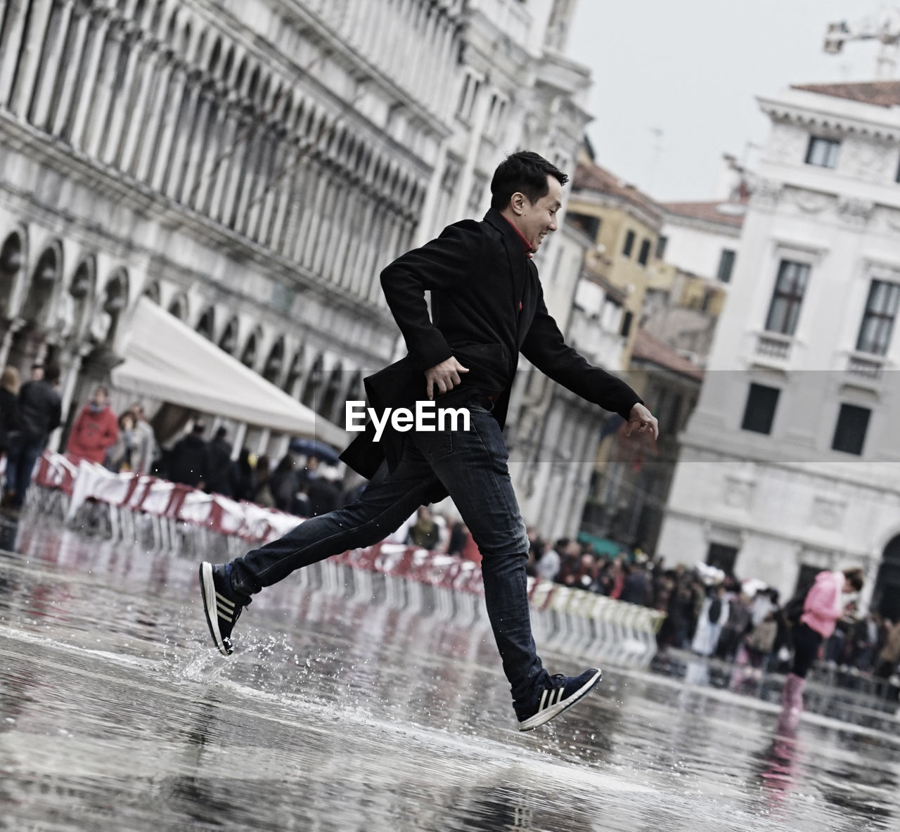 YOUNG MAN RUNNING IN RAIN