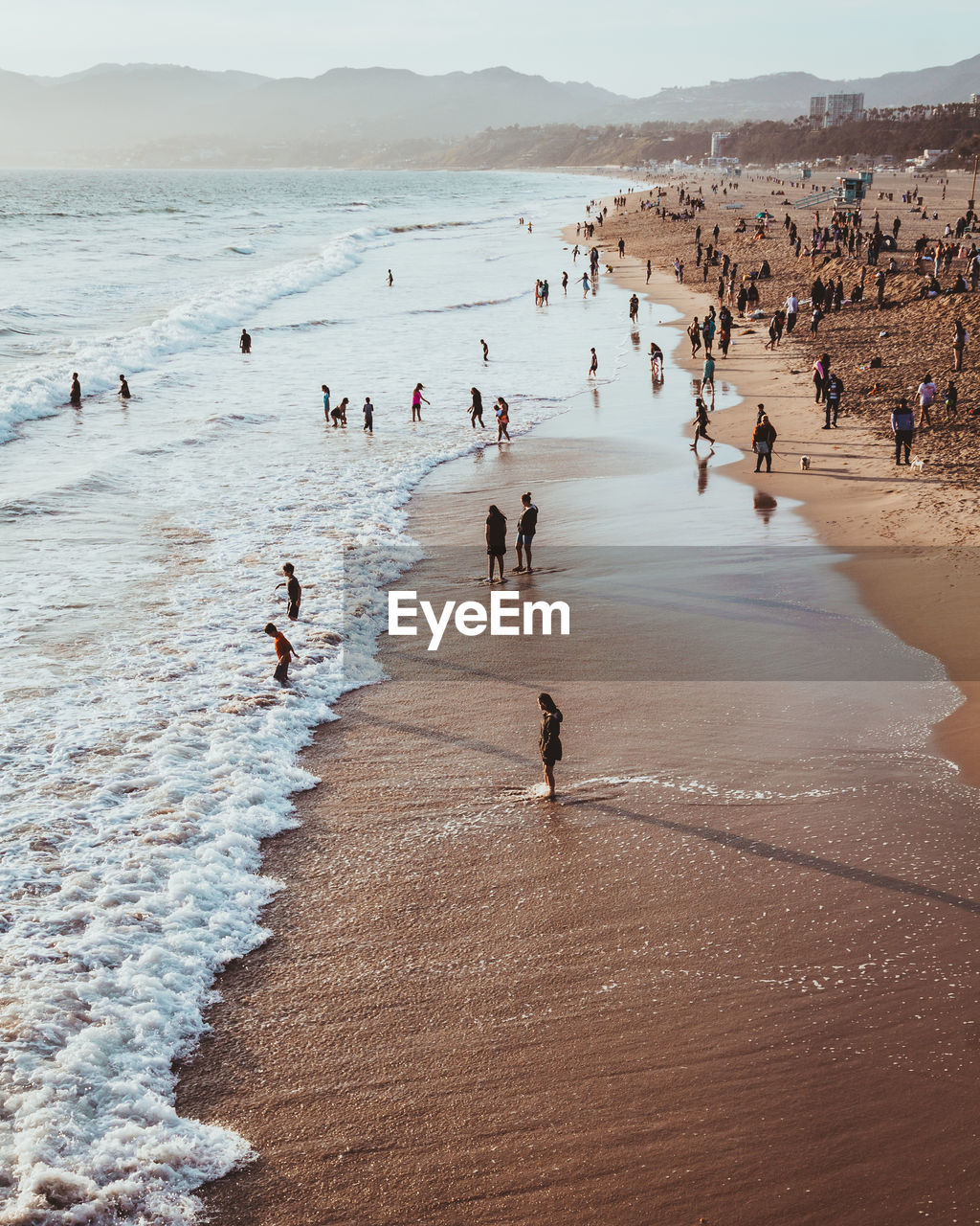 High angle view of people at beach during sunset