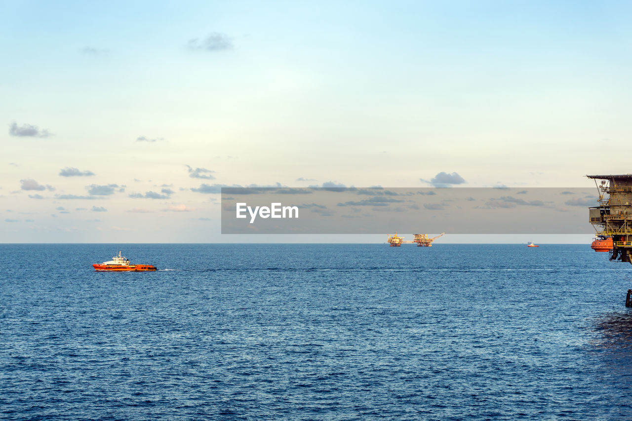 A fast crew boat leaving an oil production platform for a crew change at offshore oil field