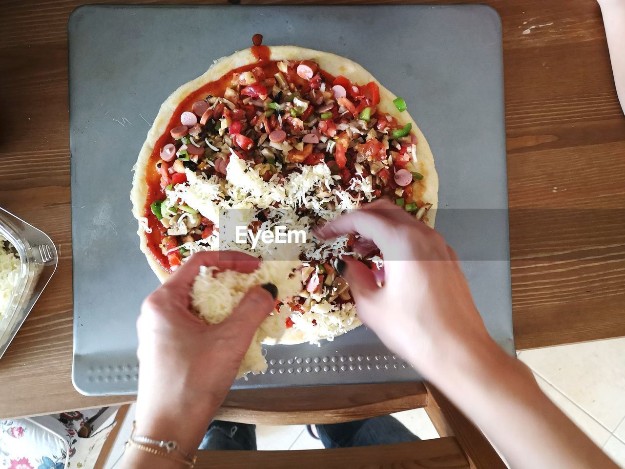 High angle view of hand holding pizza