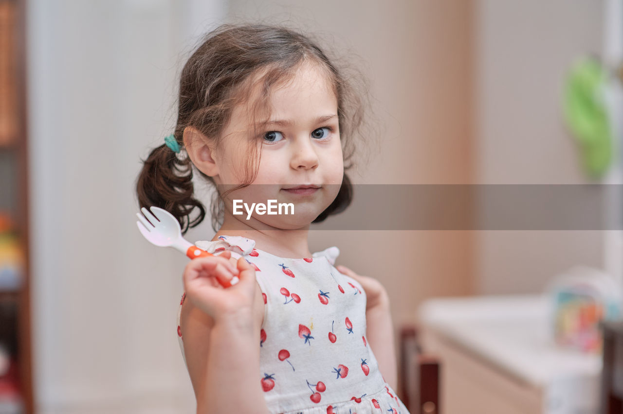 Cute girl talking while eating