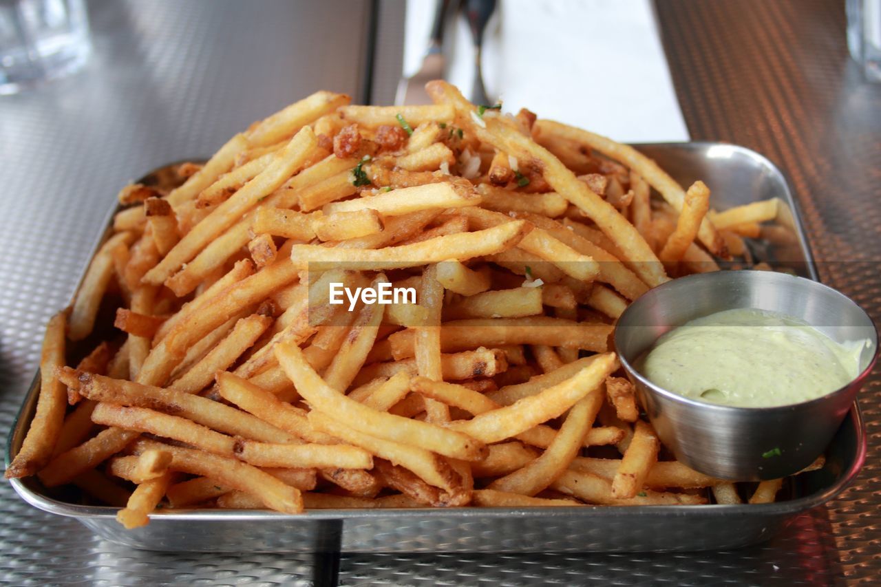 Close-up of french fries in plate on table
