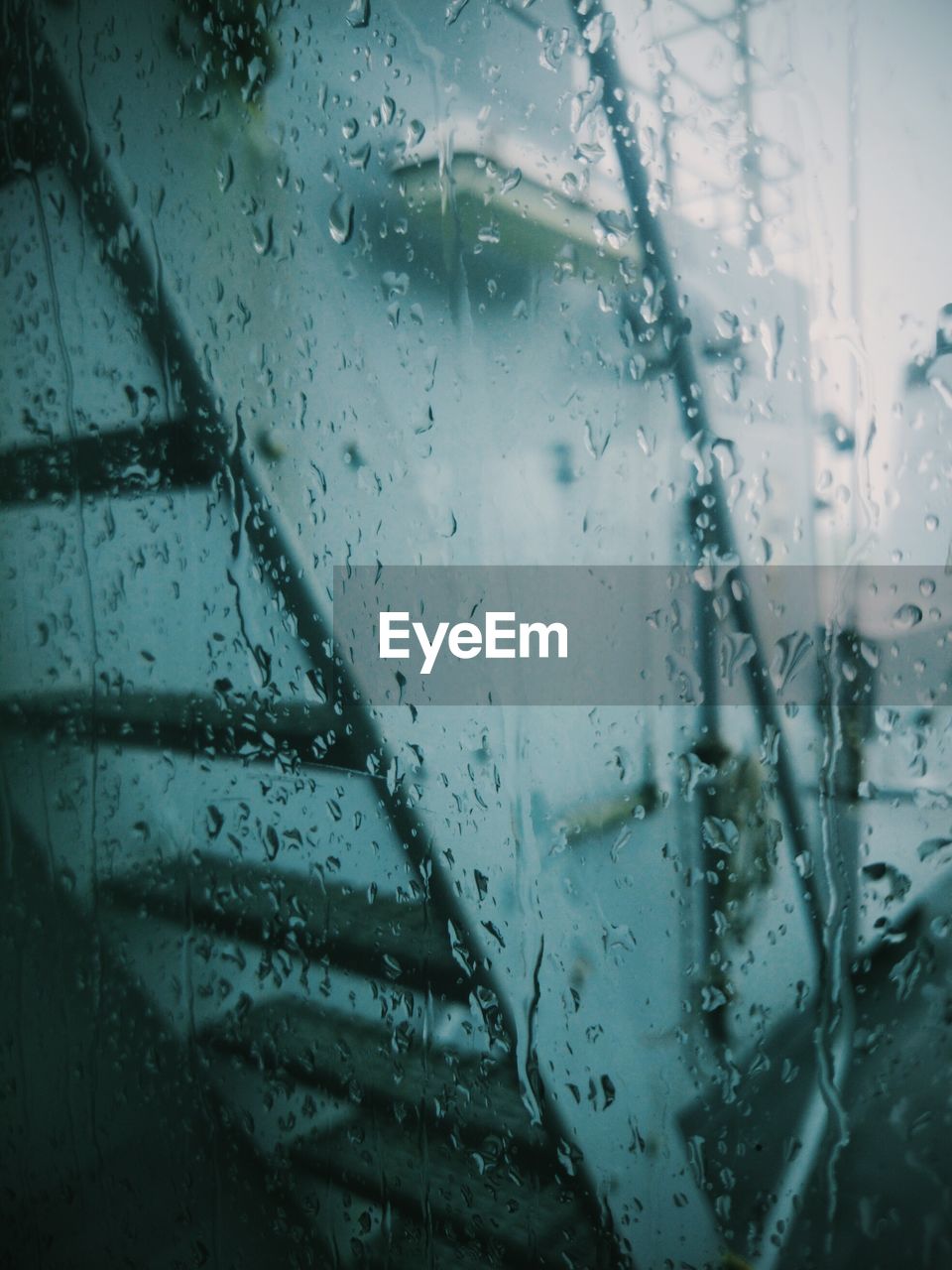 Rain drops on glass window of eml admiral pitka against staircase