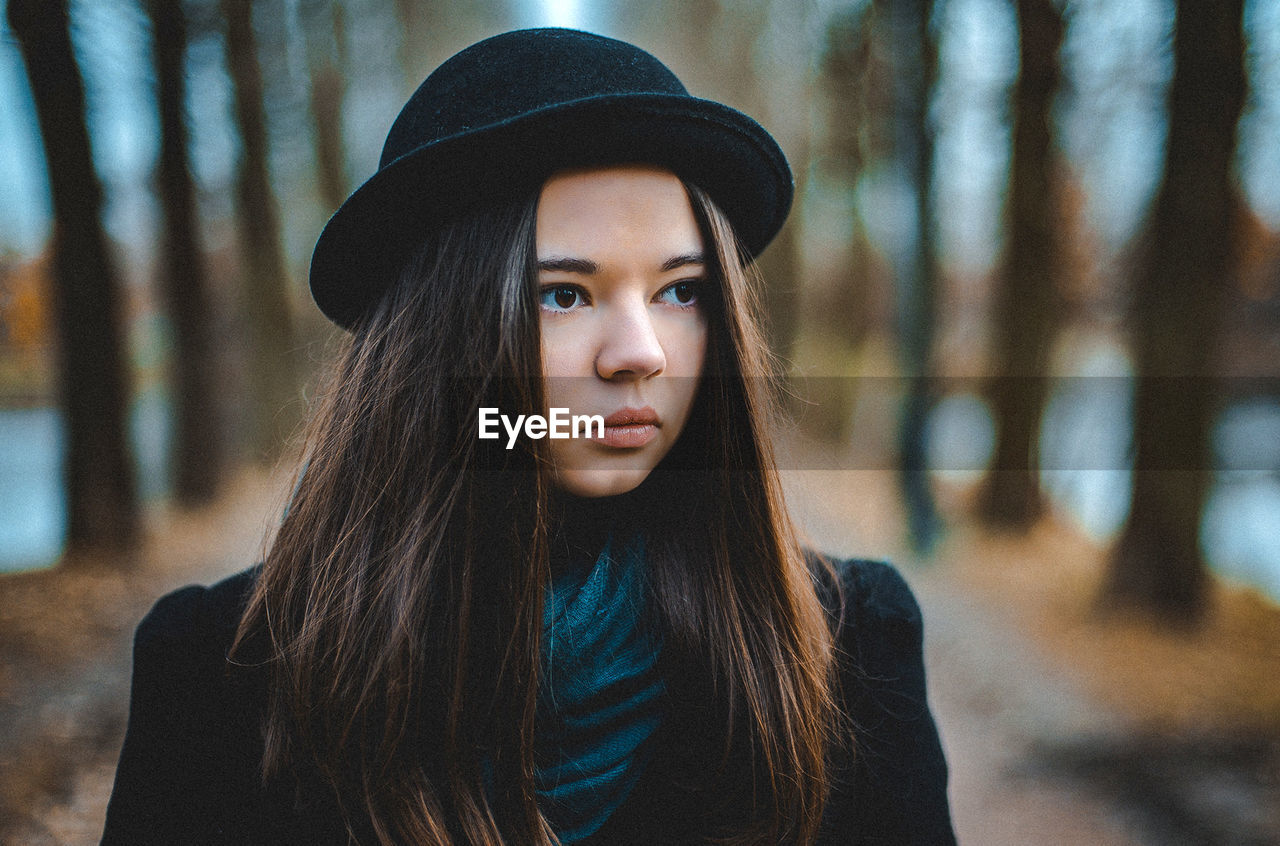 Portrait of beautiful young woman wearing hat