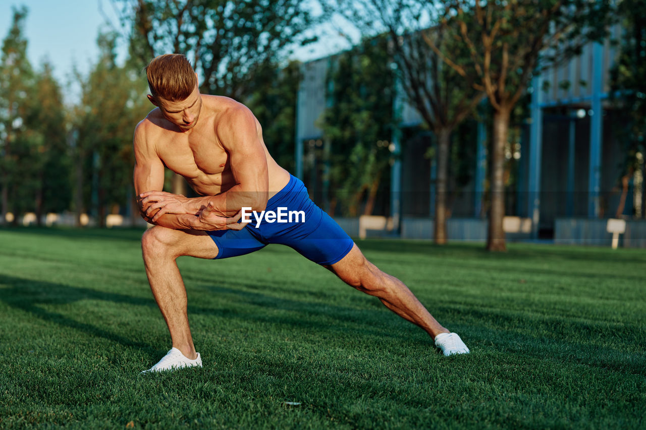 Full length of man sitting on grass