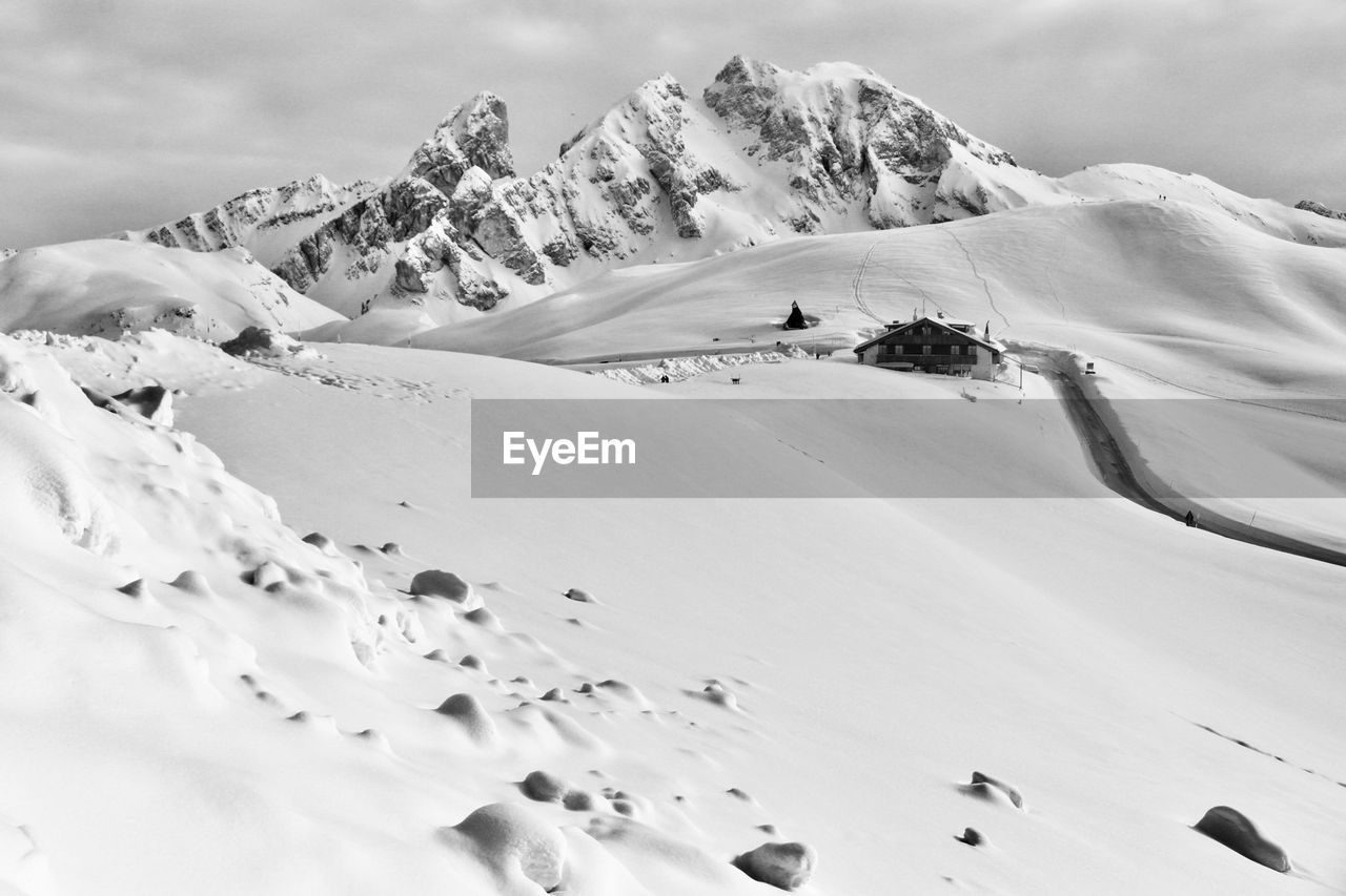 Scenic view of snow covered mountains against sky