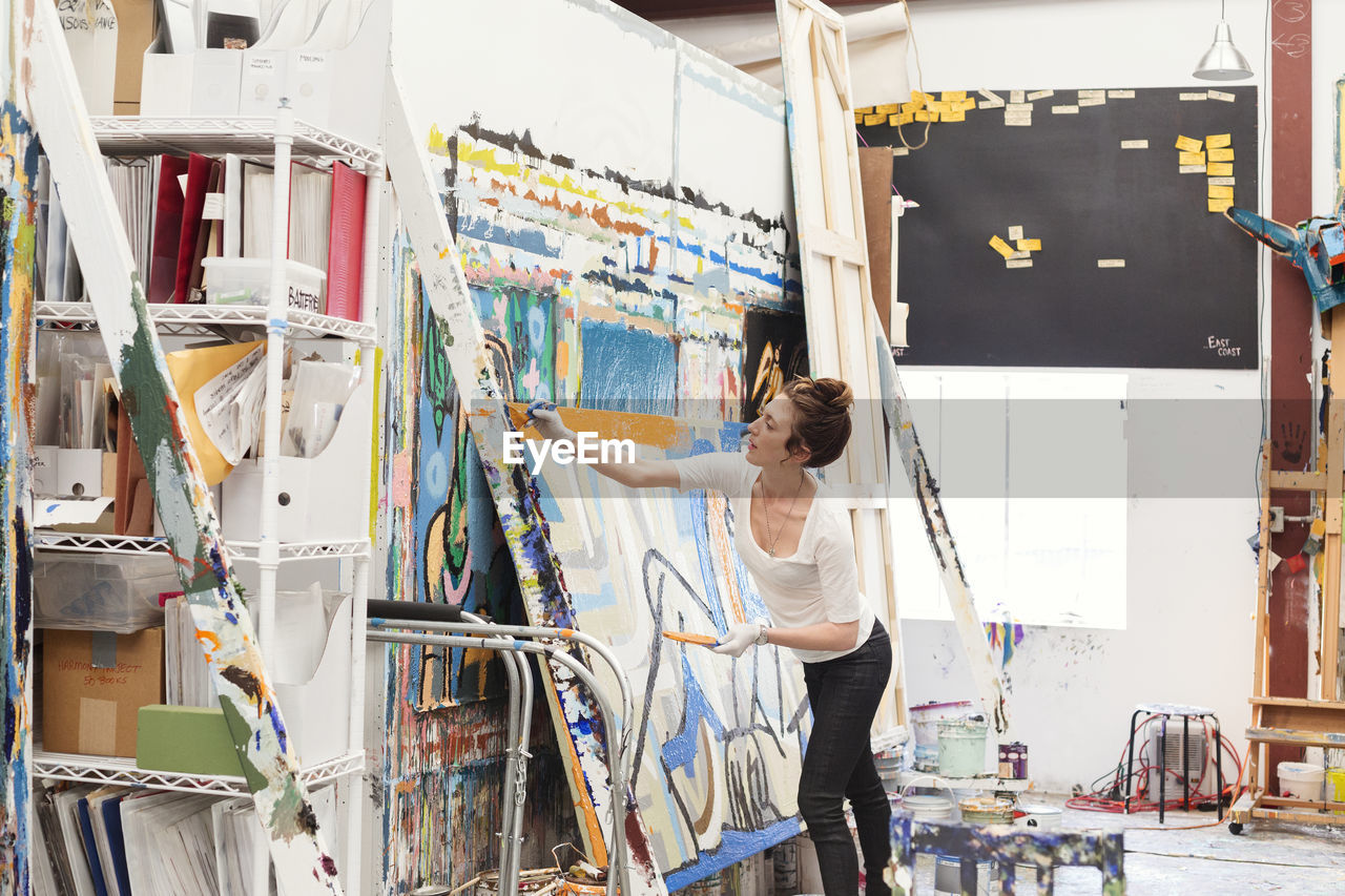 Young woman painting in art studio