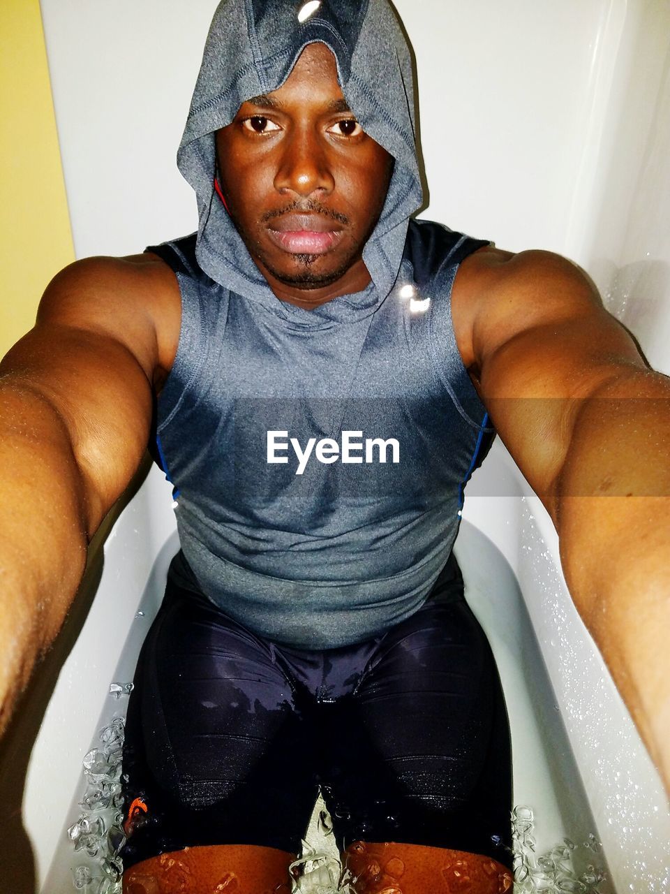 Portrait of man having ice bath