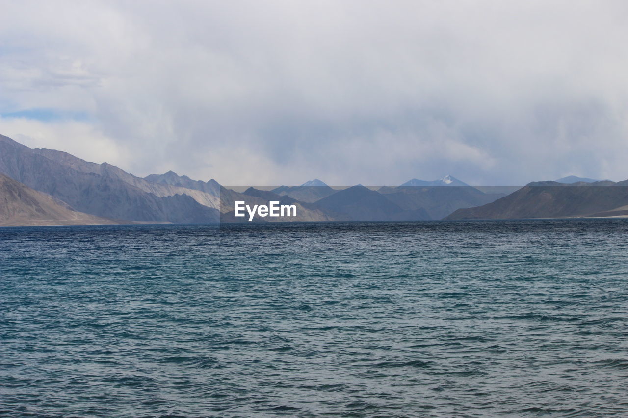 Scenic view of sea against cloudy sky