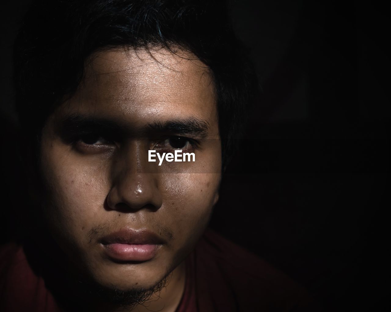 Close-up of a man face with dark background