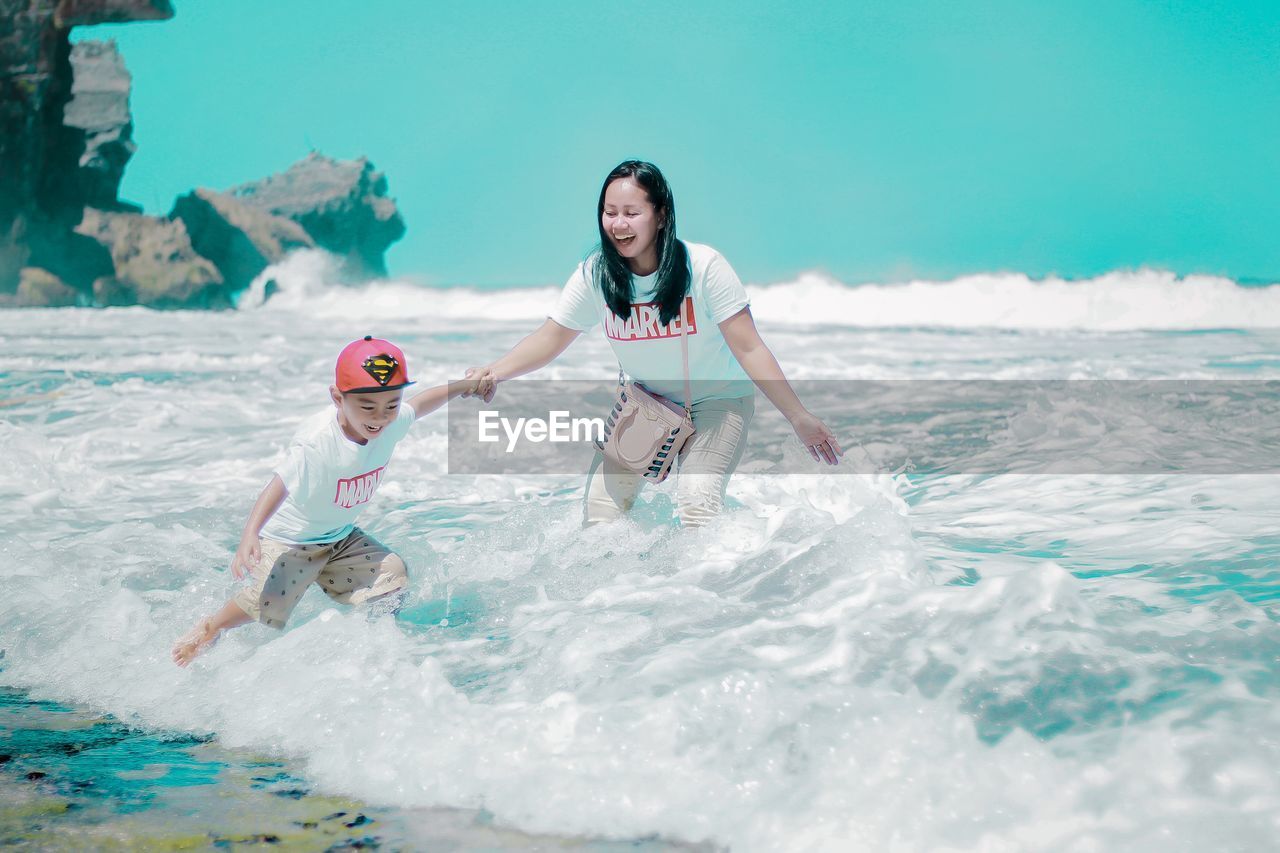 PEOPLE ENJOYING IN SEA