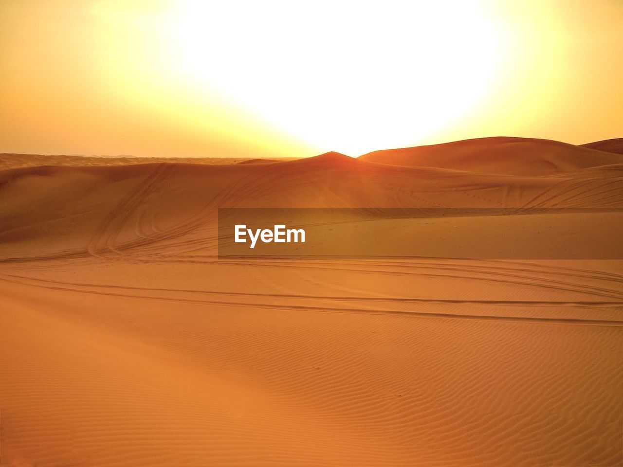 Scenic view of desert against sky during sunset