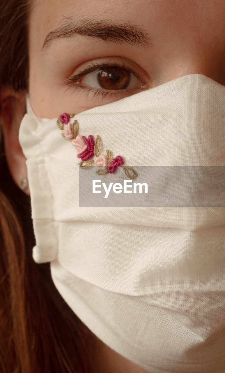 Close-up portrait of woman wearing mask