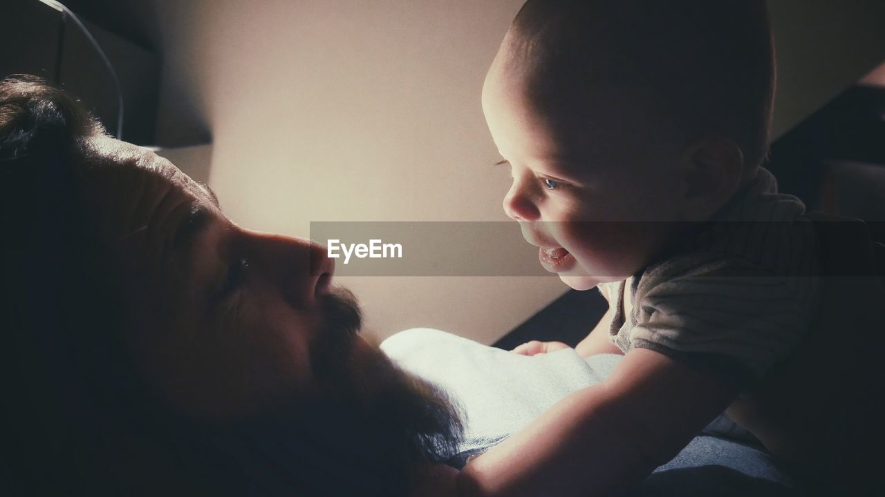 Close-up of father holding baby hand