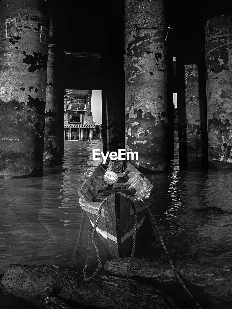 MAN SITTING BY OLD BUILDING