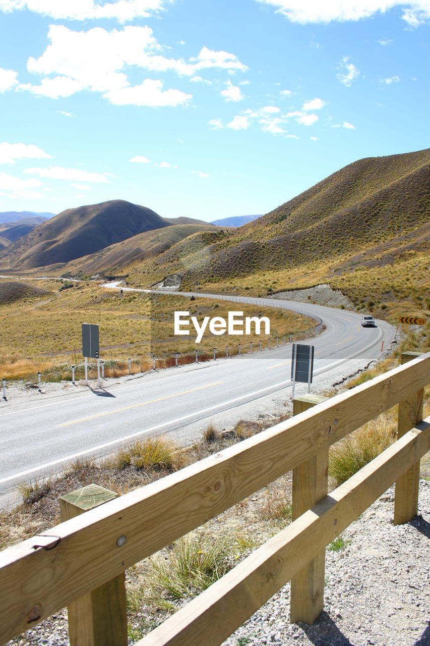 ROAD LEADING TOWARDS MOUNTAINS AGAINST SKY