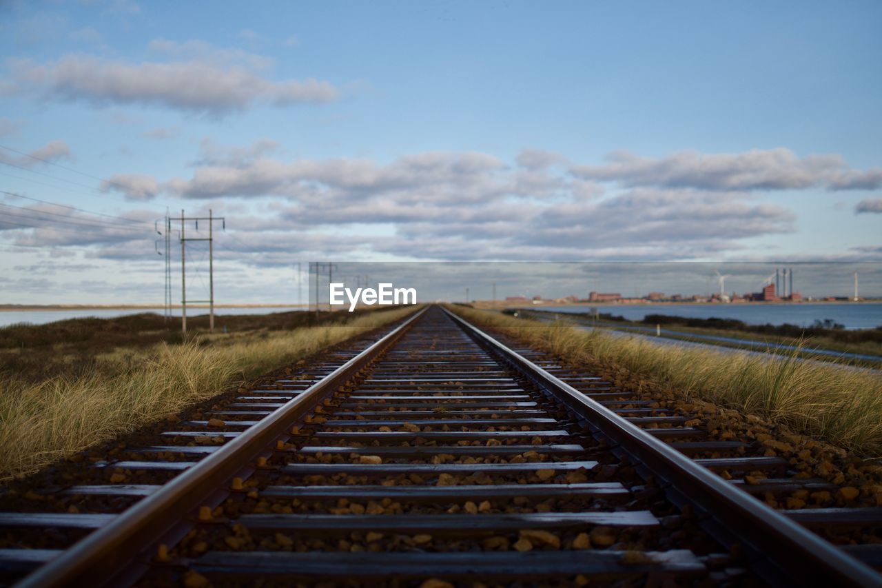 Surface level of railroad tracks against sky