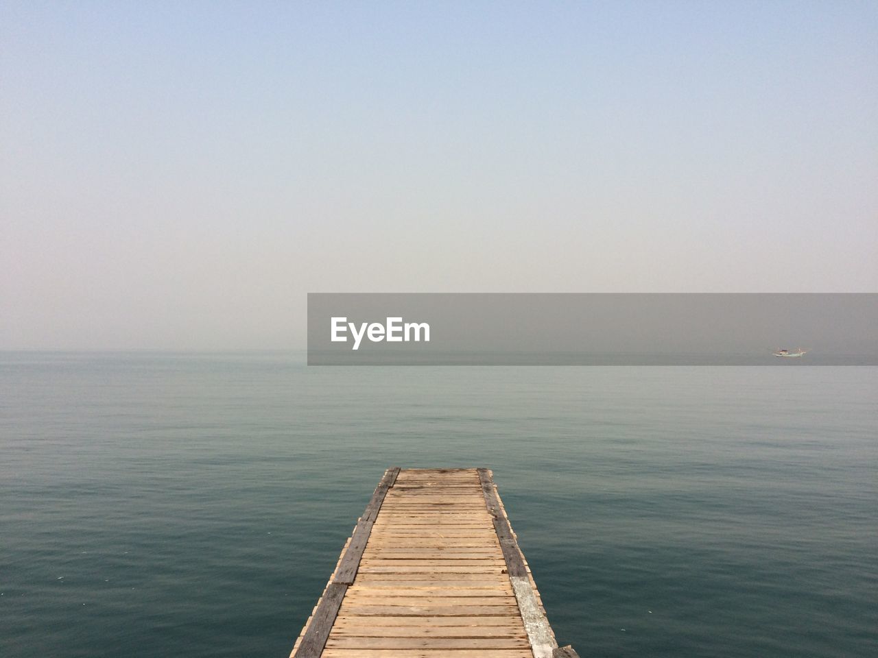 Pier over sea against clear sky