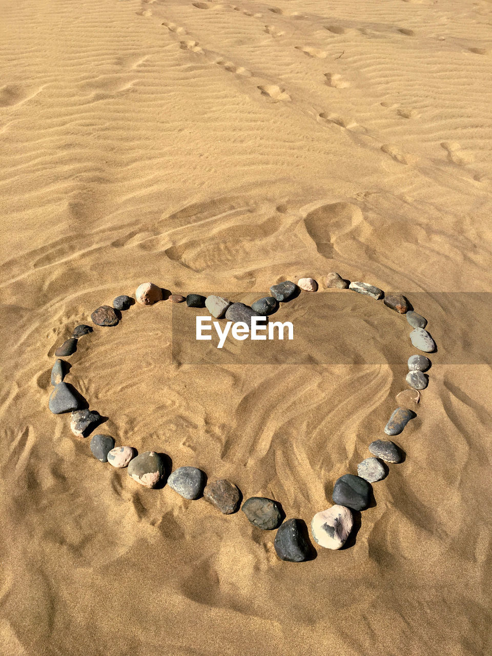 High angle view of stones arranged in heart shape on and