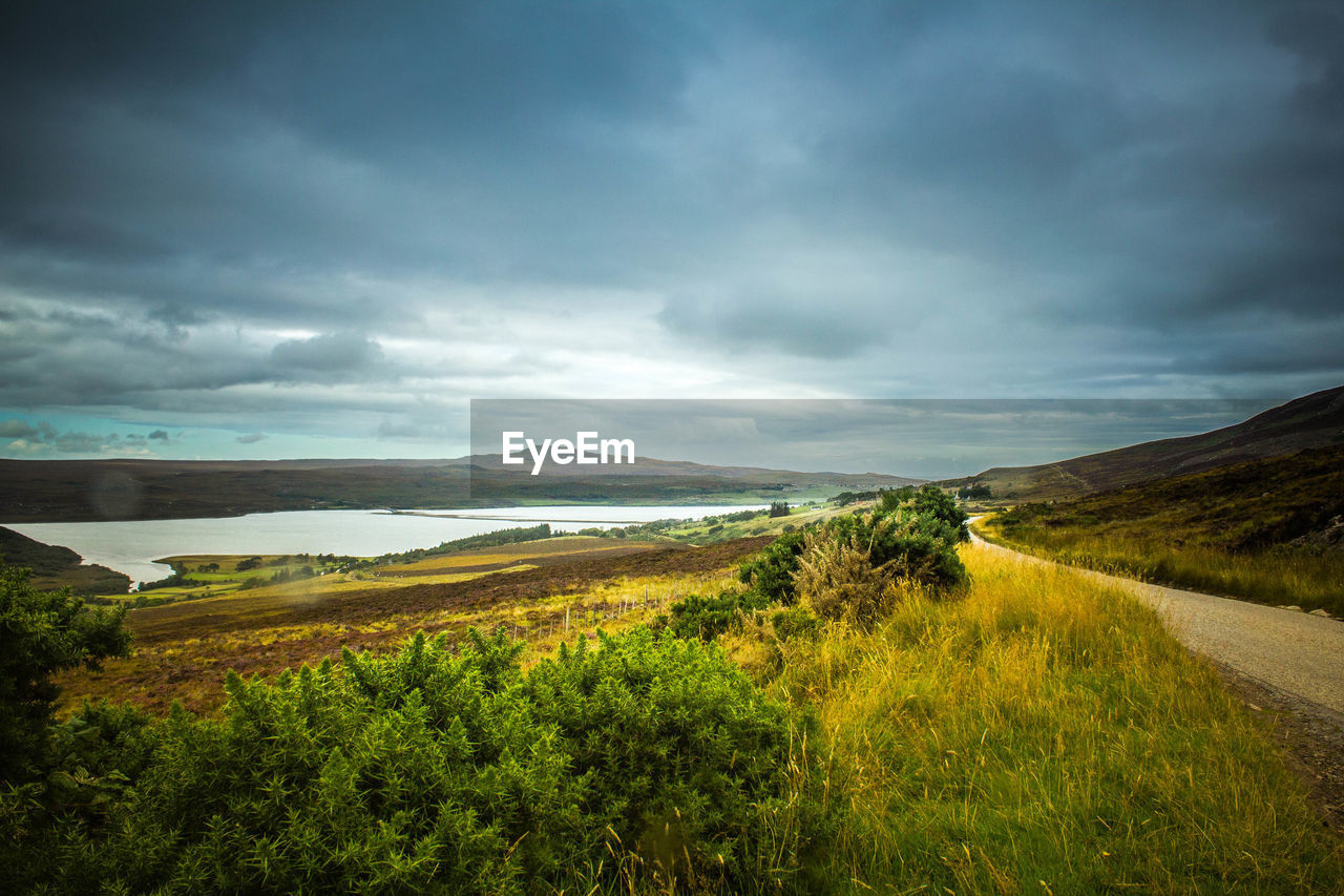 Scenic view of landscape against cloudy sky