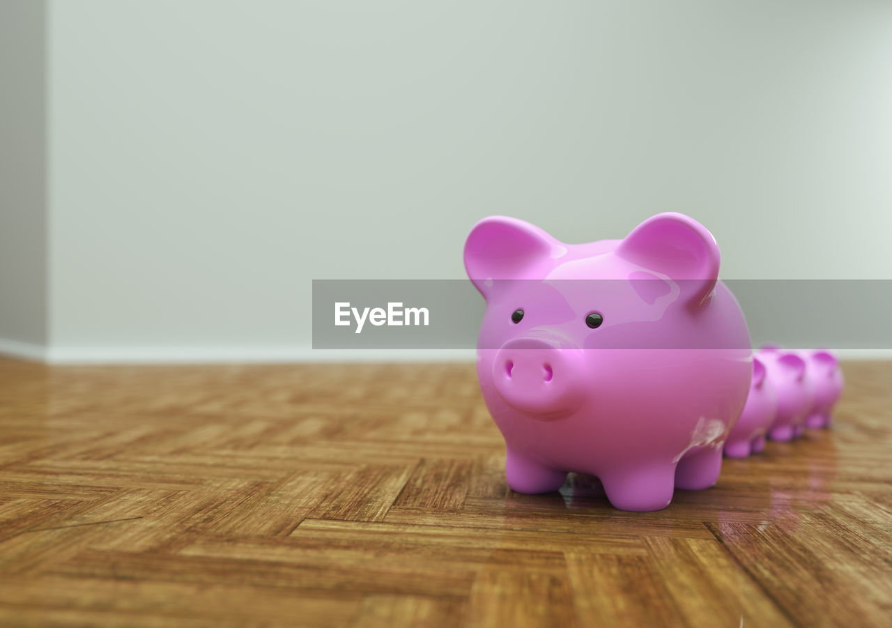 Piggy banks on hardwood floor