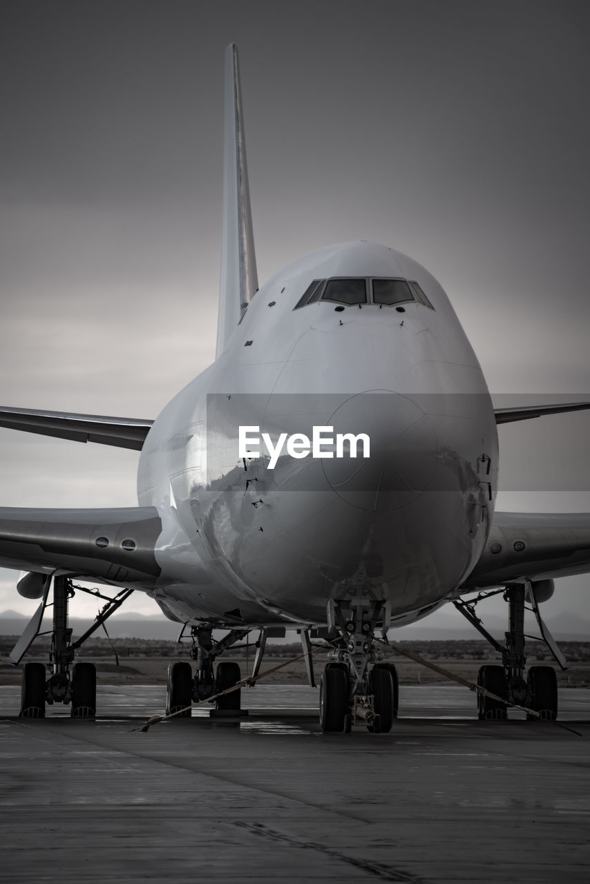 Airplane on runway against sky