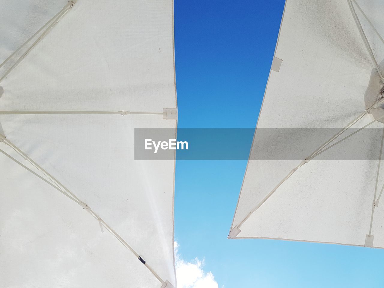 Low angle view of white building against blue sky