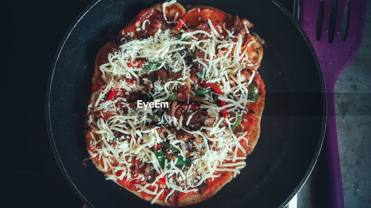 Directly above shot of pizza in cooking pan at home