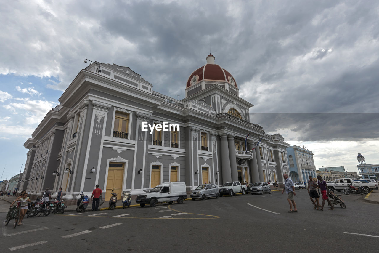 VIEW OF CITY STREET WITH CLOUDY SKY