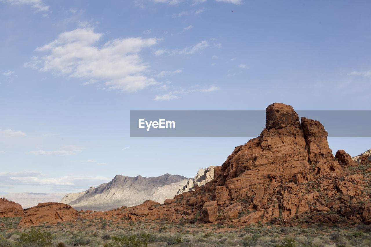 rock, sky, landscape, environment, scenics - nature, rock formation, nature, cloud, beauty in nature, land, travel destinations, natural environment, mountain, desert, wilderness, non-urban scene, geology, valley, travel, no people, semi-arid, tranquility, plateau, climate, outdoors, tranquil scene, physical geography, arid climate, day, remote, plant, mountain range, tourism, extreme terrain, eroded, wadi