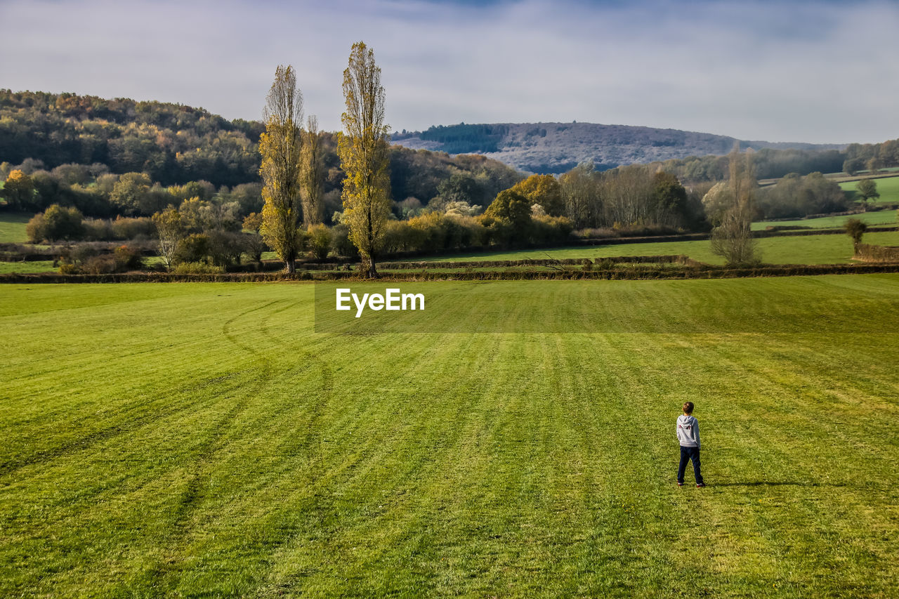 High angle view of boy standing on grassy field