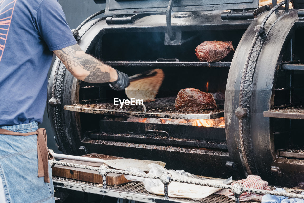 Meat cooking at a stall inside spitalfields market, london, uk.