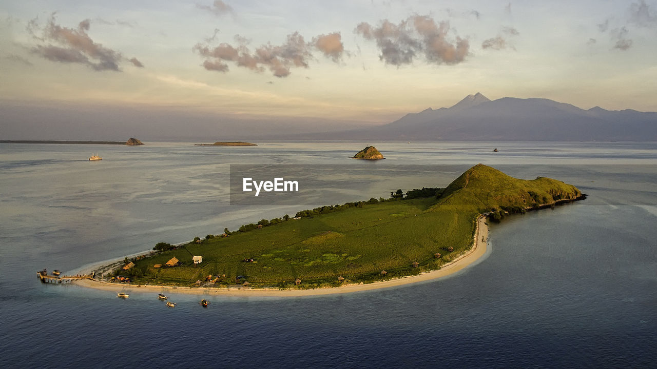 Scenic view of sea and mountains against sky