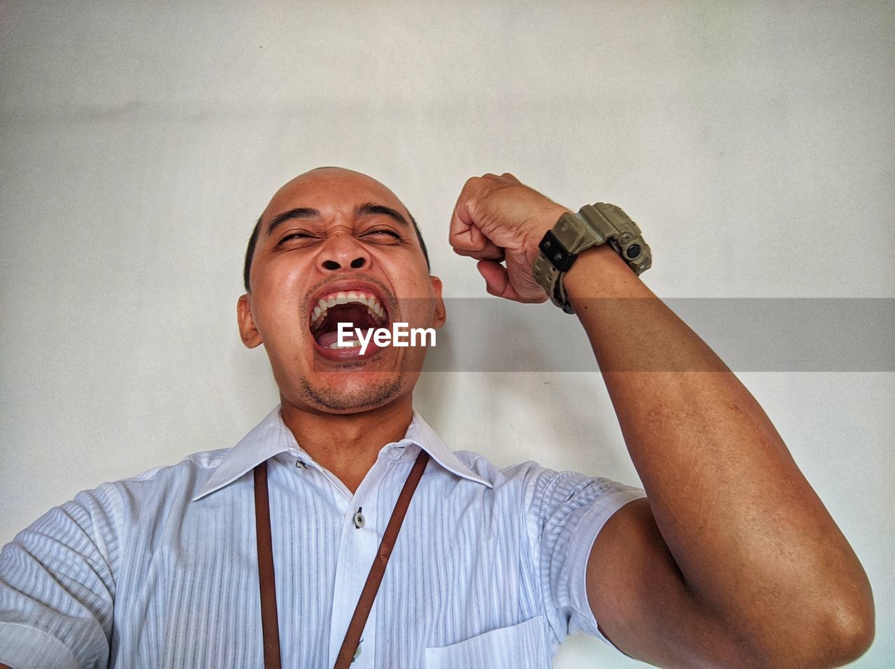 PORTRAIT OF A MAN HOLDING WALL