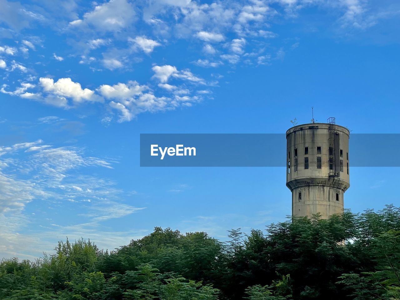 sky, architecture, tower, built structure, tree, plant, building exterior, cloud, nature, building, no people, blue, day, travel destinations, outdoors, low angle view, travel, lighthouse, history, the past, tourism