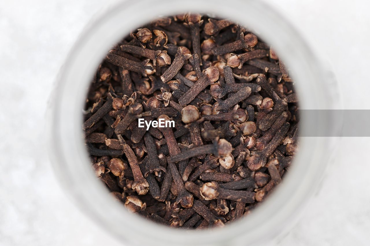 High angle view of dried cloves in container