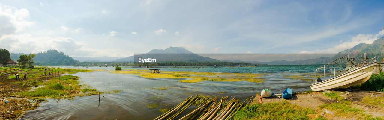 PANORAMIC VIEW OF BOATS ON LAND AGAINST SKY