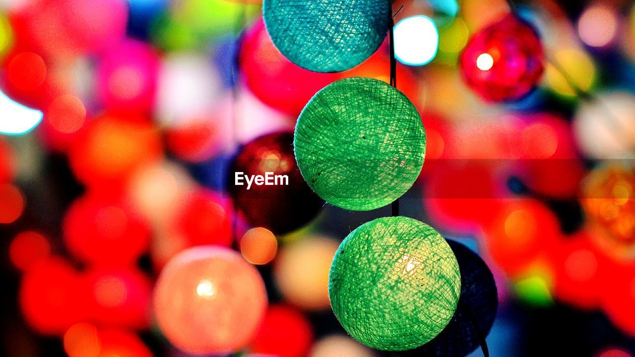 CLOSE-UP OF ILLUMINATED CHRISTMAS LIGHTS HANGING ON WALL