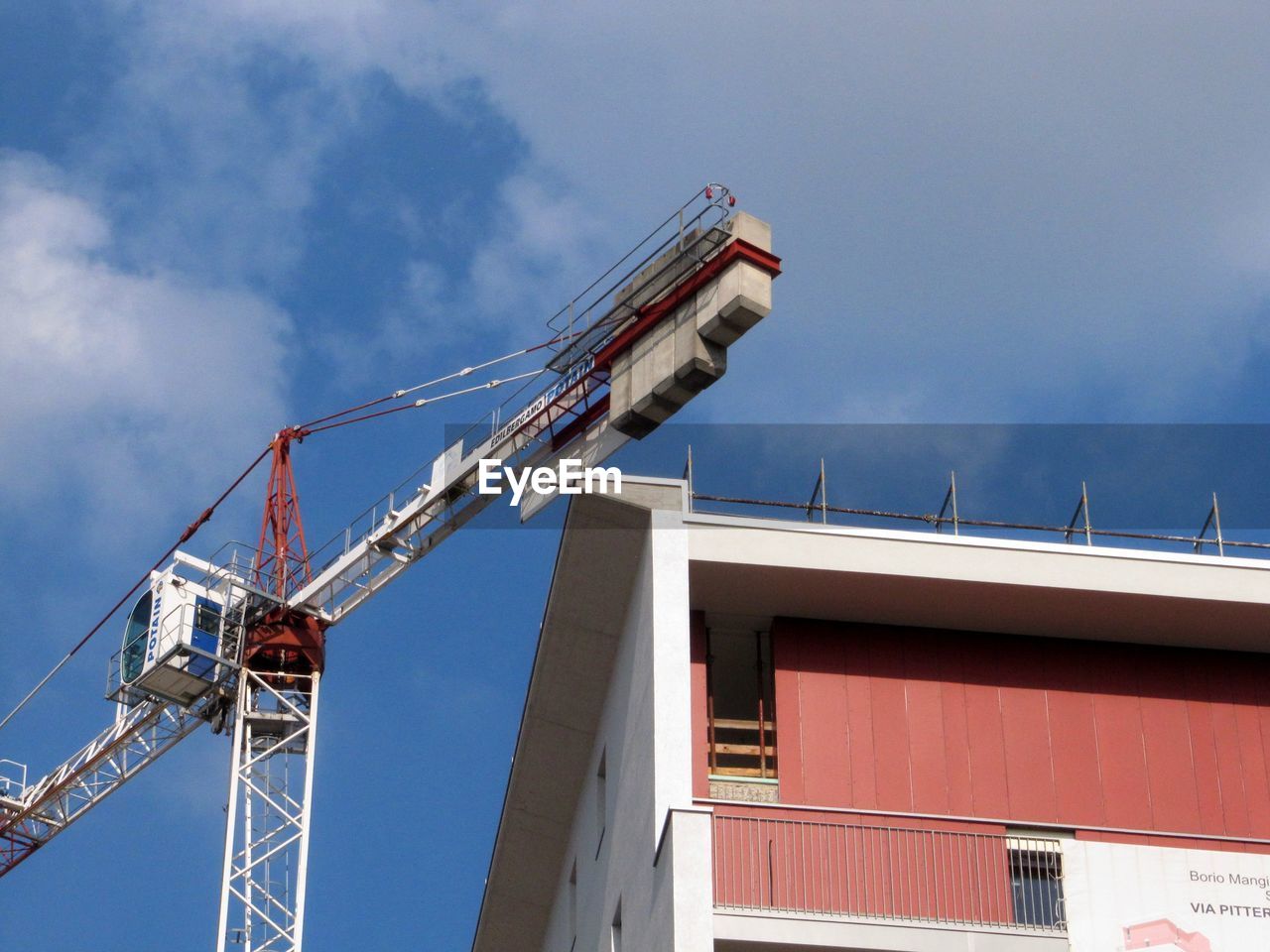 LOW ANGLE VIEW OF CRANES AGAINST SKY