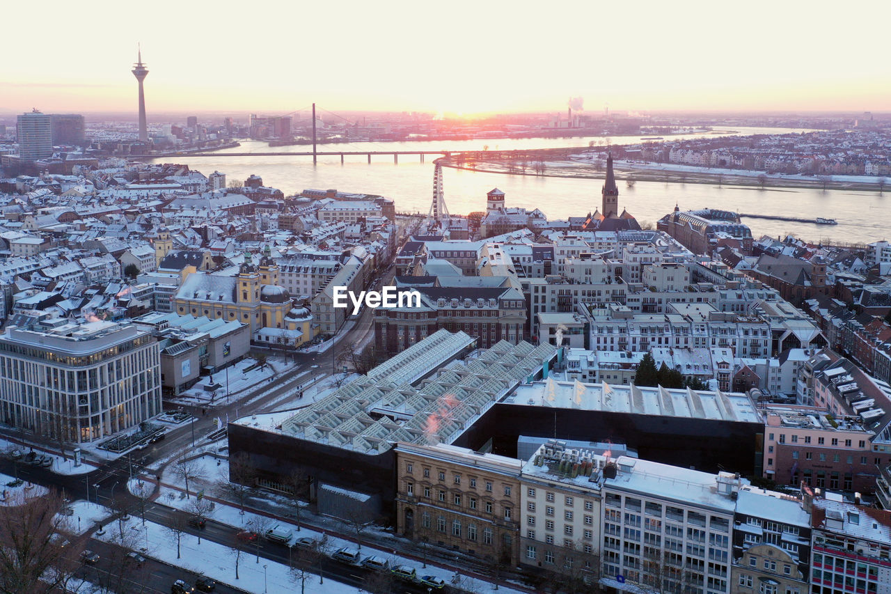 High angle view of city buildings during sunset