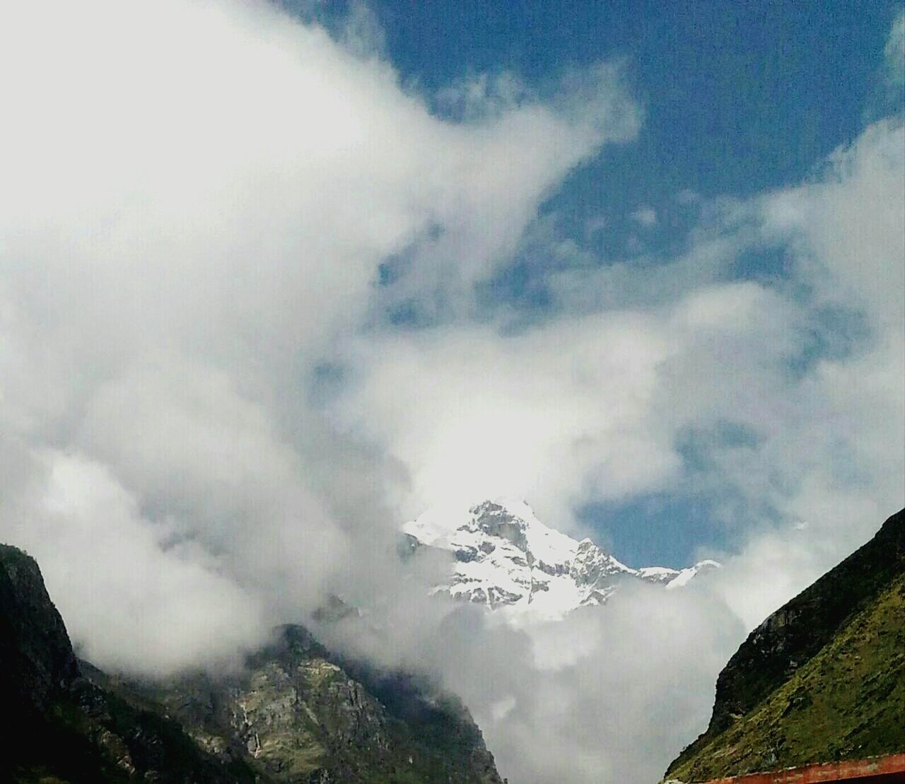 LOW ANGLE VIEW OF CLOUDS OVER MOUNTAIN