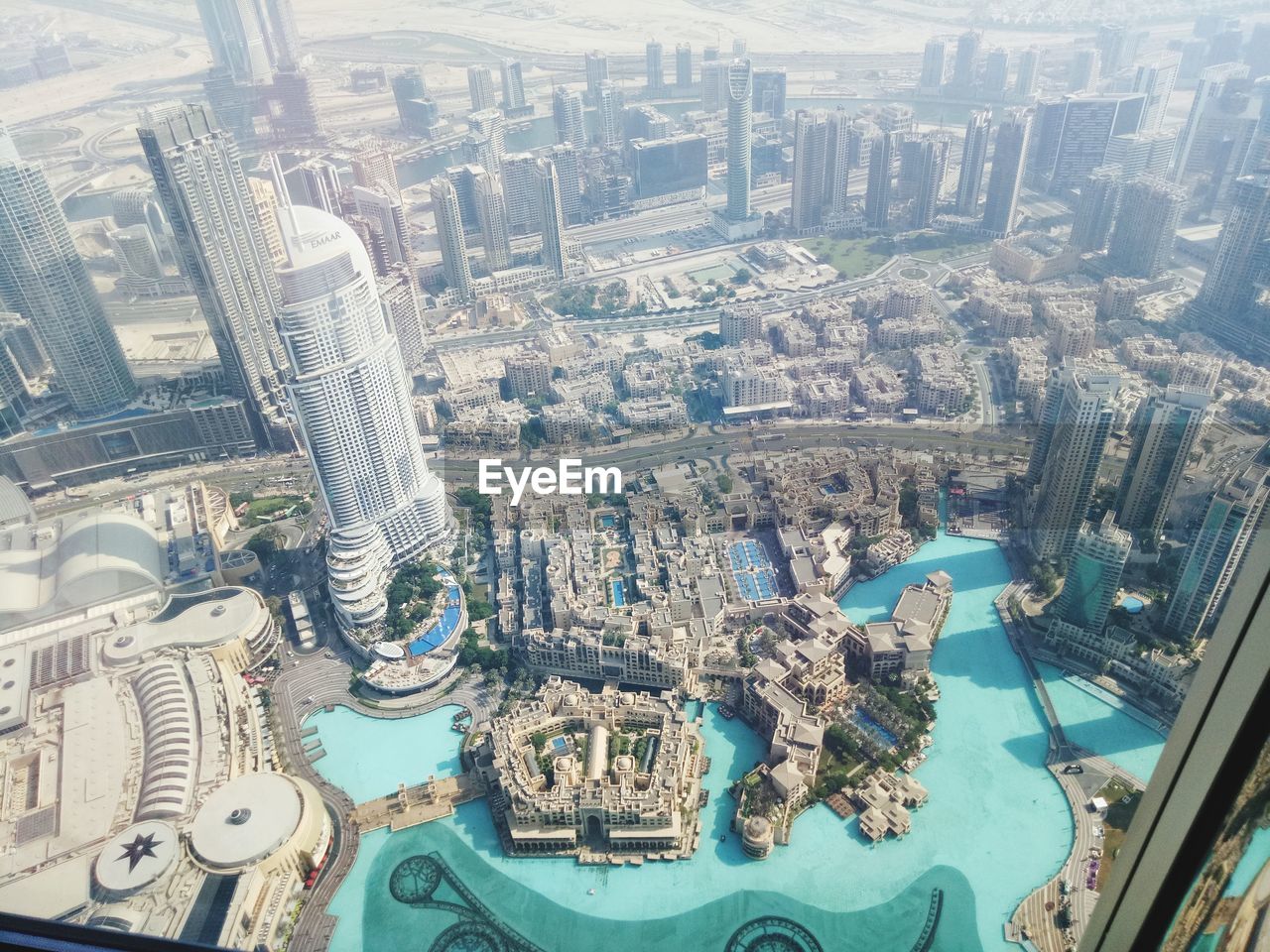 HIGH ANGLE VIEW OF CITY BUILDINGS SEEN THROUGH WINDSHIELD