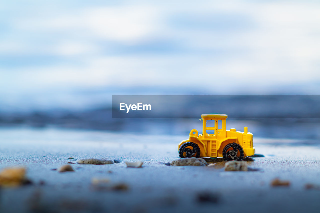Close-up of toy car on the beach