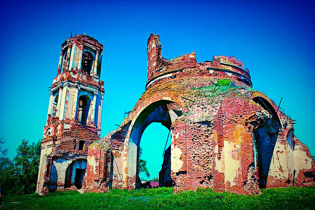 Low angle view of old ruin church against blue sky